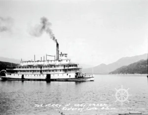 The Nasookin with a Greyhound bus on her bow, about to dock at Gray Creek.